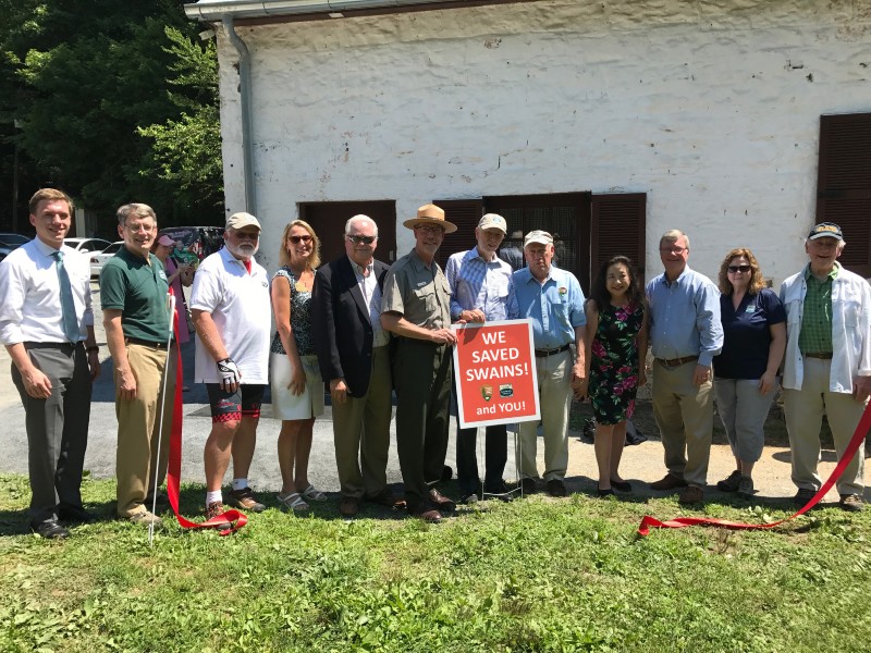 Dignitaries pose after cutting the ribbon marking Swains Lockhouse on the C&O Canal open, 2019.